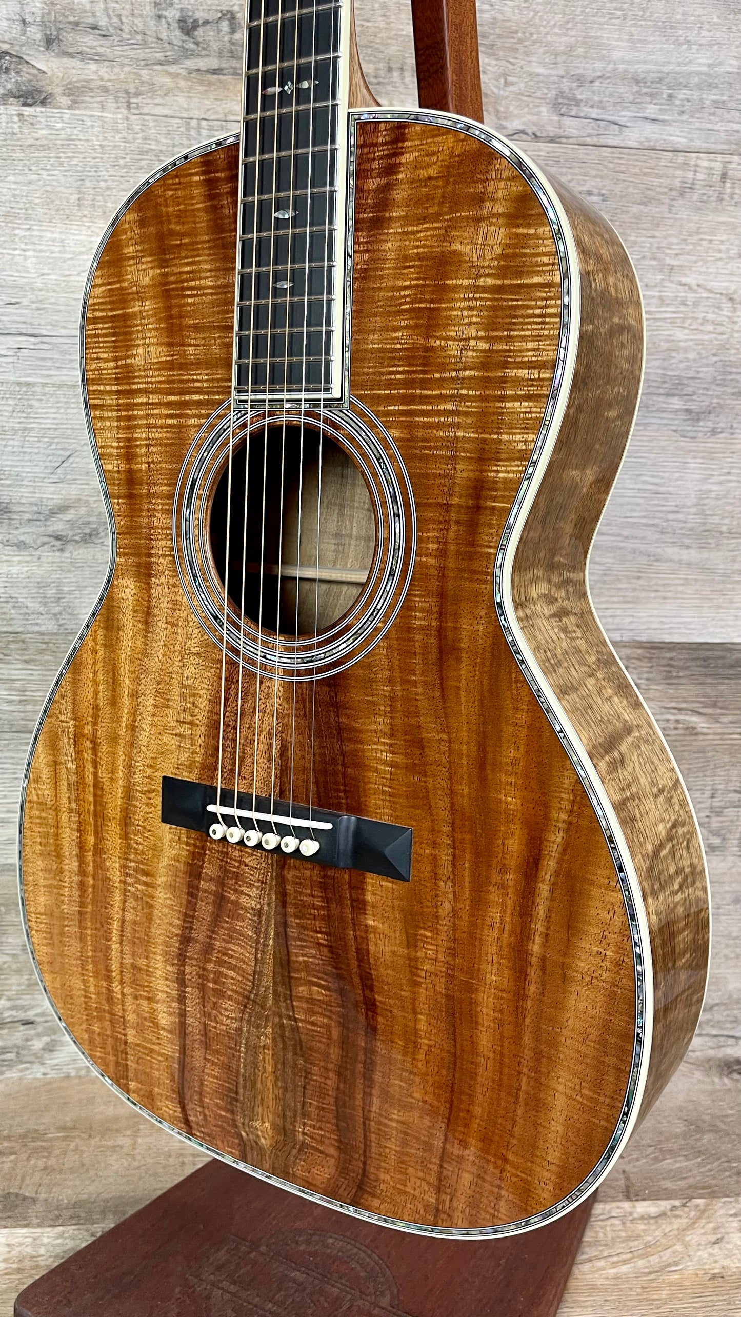 Front right angle of Martin Custom Shop 42 Style 000 12-Fret All Highly Flamed Koa.
